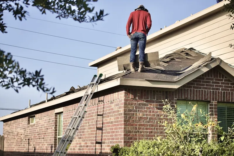 Professional roofer working on a residential roof in Caledonia